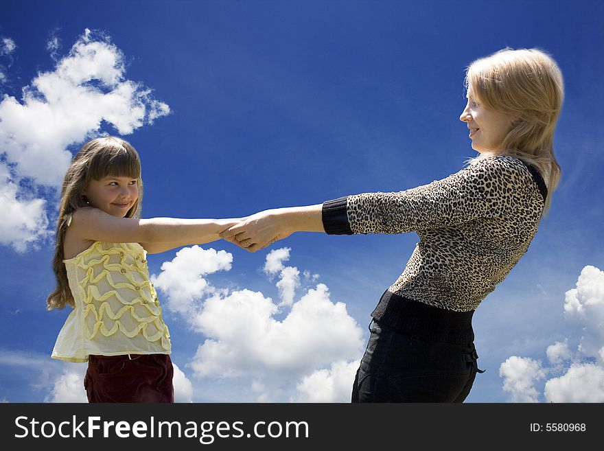 The mother and the daughter against the sky. The mother and the daughter against the sky