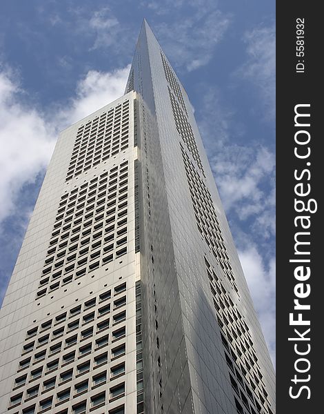 One of Singapore's well known urban landmarks (OUB Building) against the cloudy sky. One of Singapore's well known urban landmarks (OUB Building) against the cloudy sky