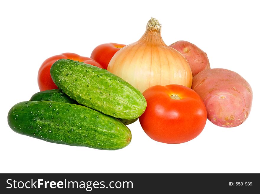 Cucumbers, tomatoes, potato and onion on a white background. Cucumbers, tomatoes, potato and onion on a white background
