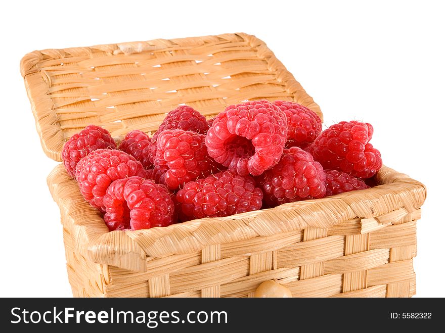 The bast-basket with a raspberry is photographed on a white background