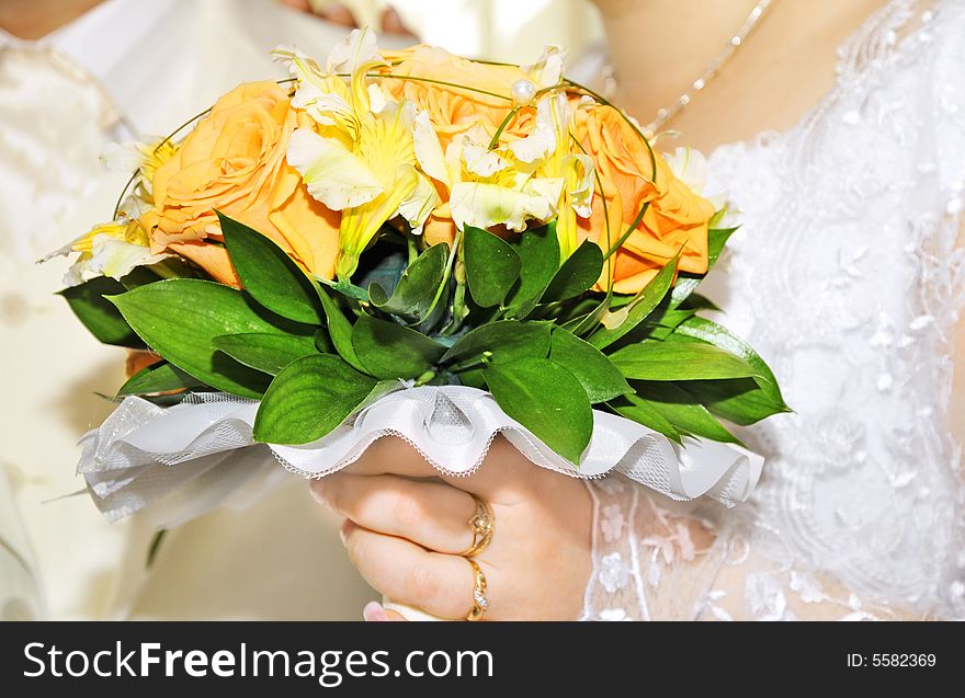 Groom and bride with wedding bouquet of fresh roses. Groom and bride with wedding bouquet of fresh roses