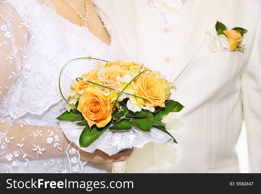 Groom and bride with wedding bouquet of fresh roses. Groom and bride with wedding bouquet of fresh roses