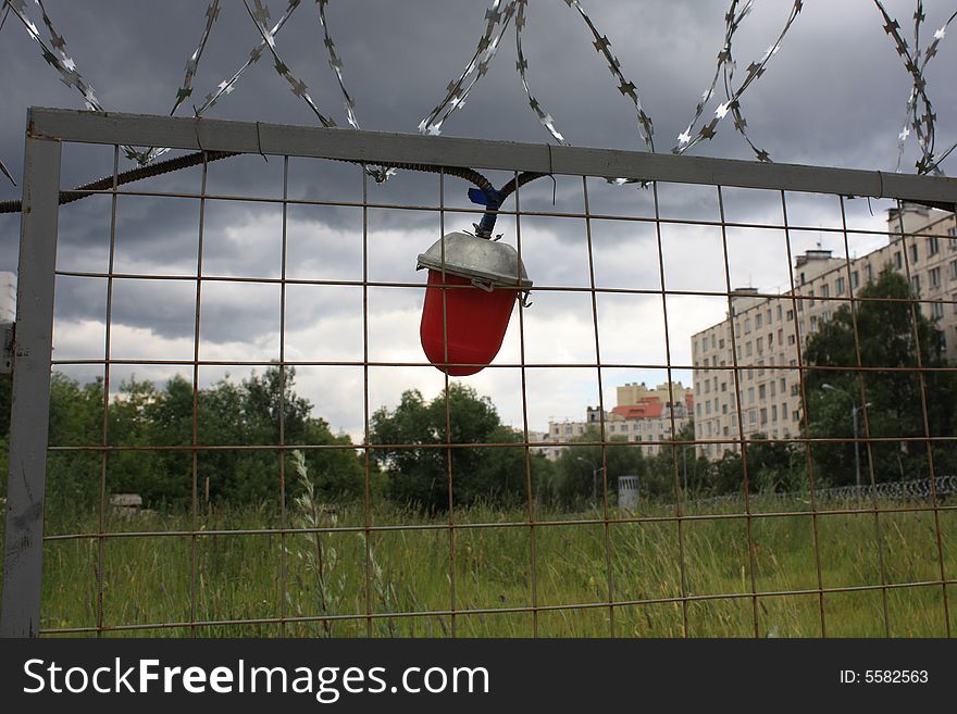 Lantern on a fence with a prickly wire