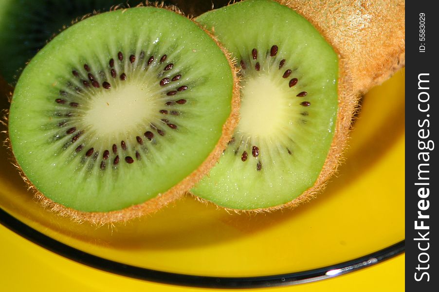Slices of kiwi cut in glass plate. Slices of kiwi cut in glass plate