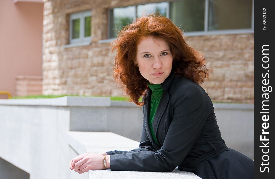 Redhead curly girl urban portrait