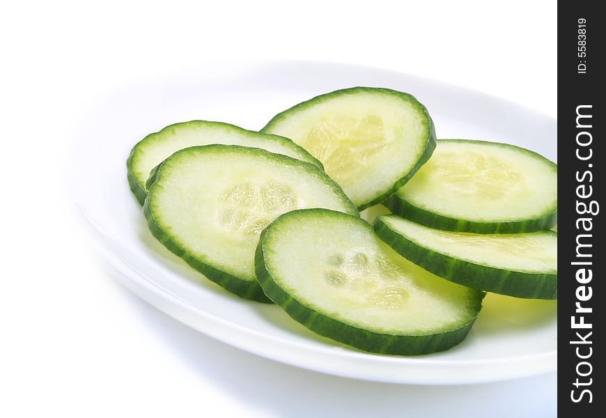 Fresh sliced cucumber on a white plate. Fresh sliced cucumber on a white plate