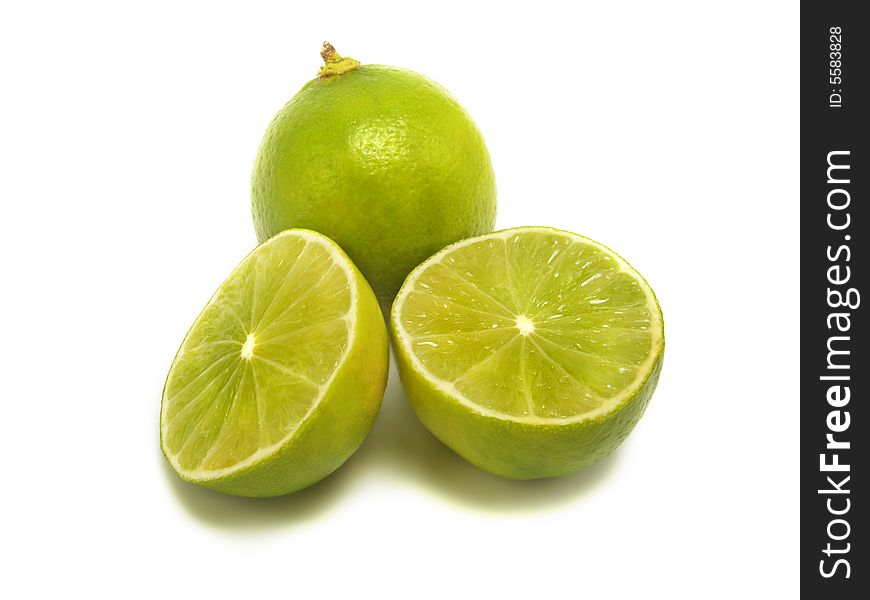 A group of half and whole fresh limes isolated on white background. A group of half and whole fresh limes isolated on white background
