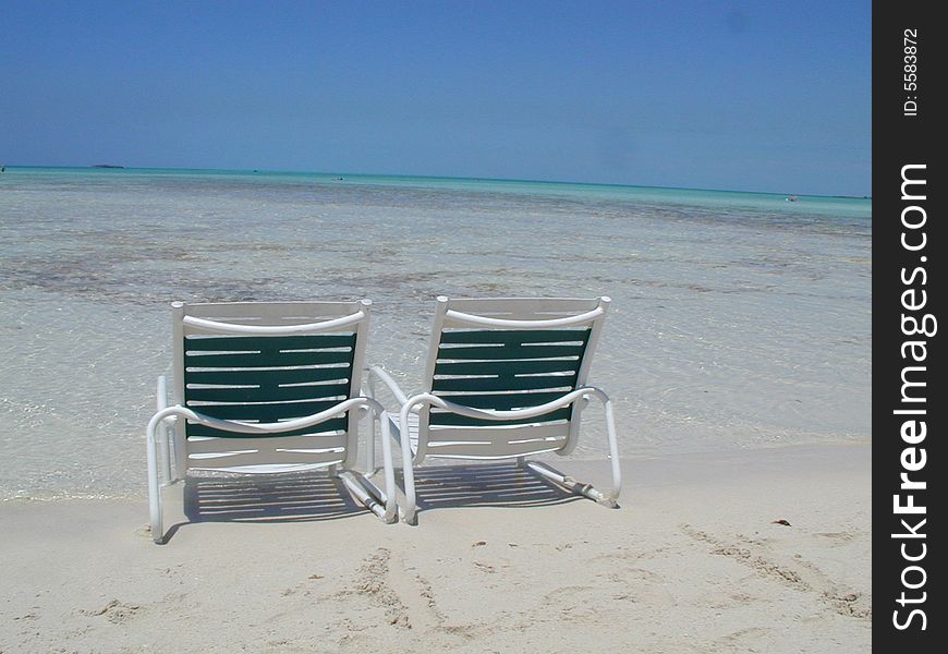 Ahhh - the privacy of your very own Caribbean beach!  Two beach chairs look inviting on this white sand outlined by beautiful tropical aqua blue waters. Ahhh - the privacy of your very own Caribbean beach!  Two beach chairs look inviting on this white sand outlined by beautiful tropical aqua blue waters.