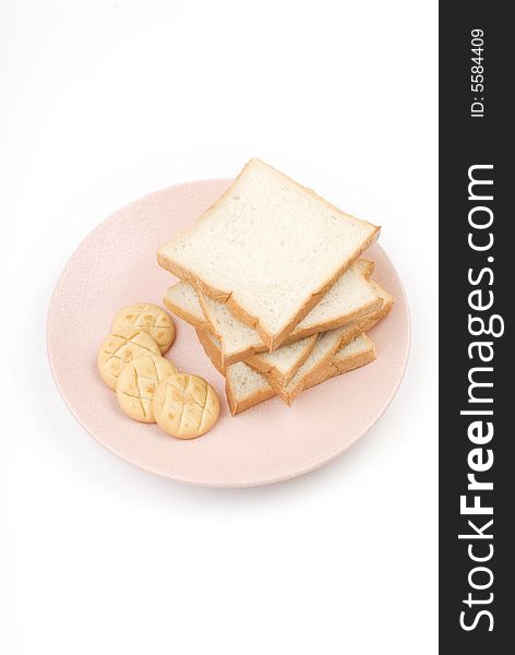 Toast and cookies in the plate with white background.