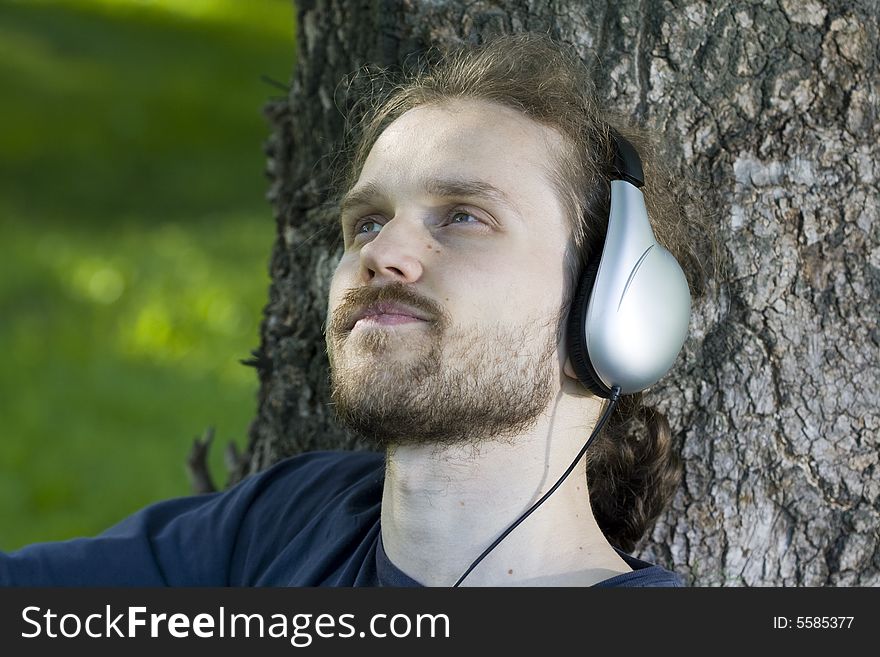 Young man with headphones relaxing. Young man with headphones relaxing