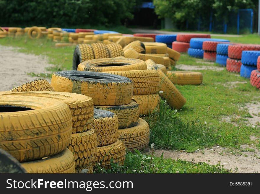 A stack of used colored car tyres