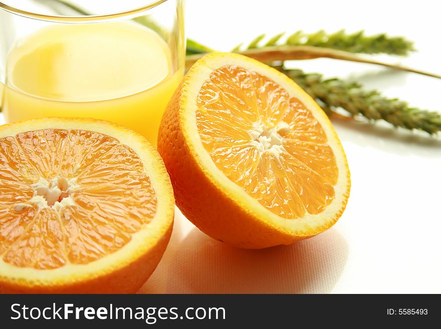 Halved orange with a glass of orange juice. Halved orange with a glass of orange juice