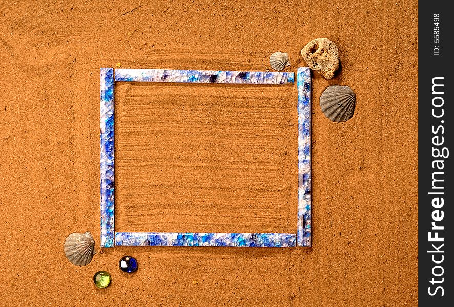 Blue frame lay in the golden sand with rocks and shells. Blue frame lay in the golden sand with rocks and shells