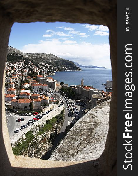 Looking out into panorama of Dubrovnik through a port hole from the old fortress (Croatia)