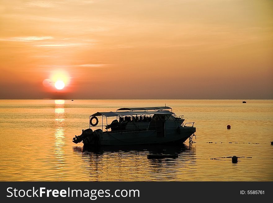 Golden sunset creating a stilling silhouette of 2 speedboats on a very calm sea. Golden sunset creating a stilling silhouette of 2 speedboats on a very calm sea