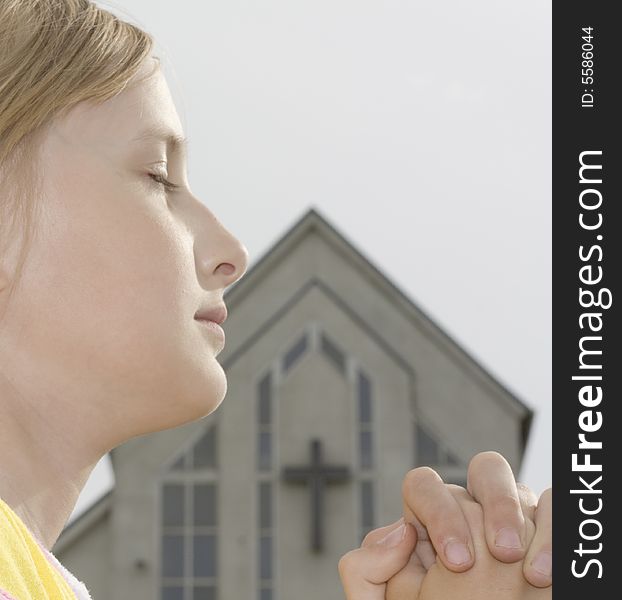 Teenager girl  praying near church. Teenager girl  praying near church