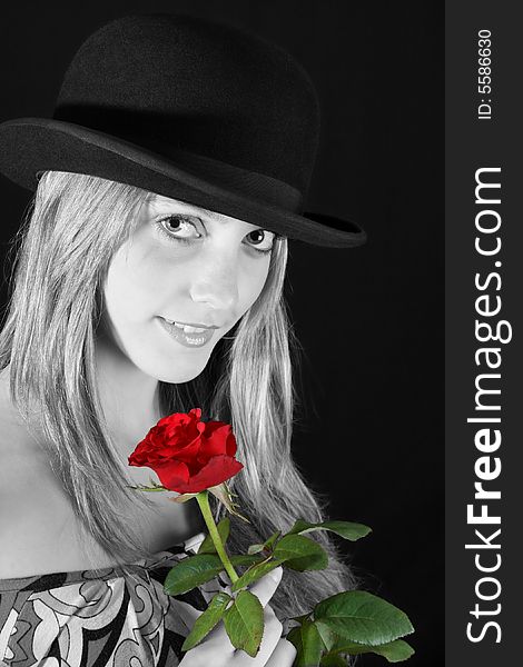 Beautiful young female model with a red rose