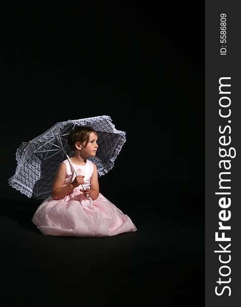 Pretty girl in a pink dress holding a white lace parasol. Pretty girl in a pink dress holding a white lace parasol