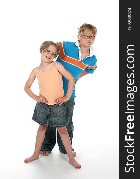 Brother and sister standing on a high key background together