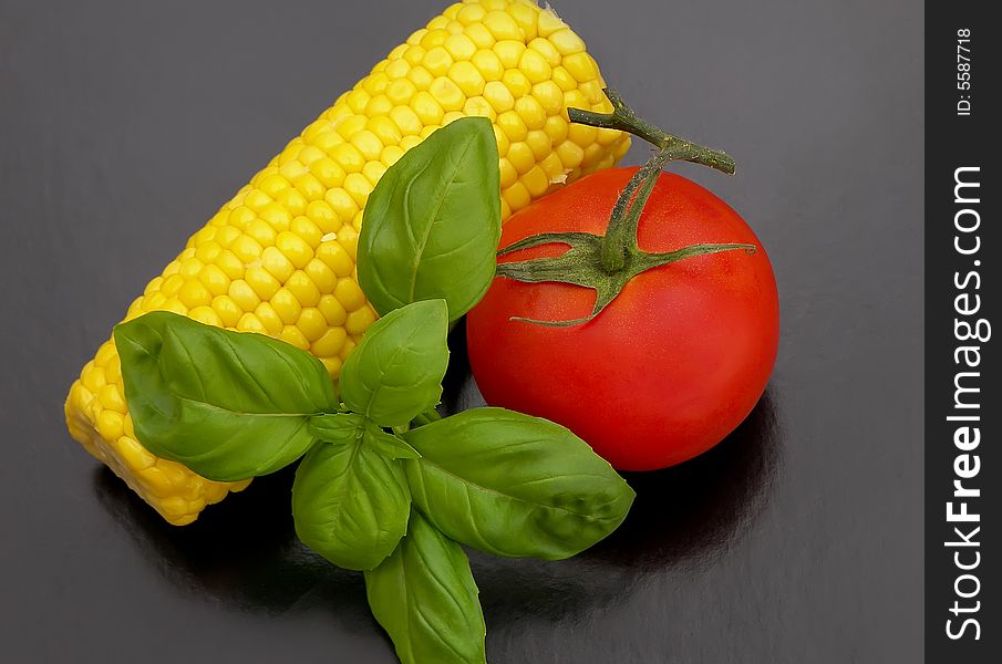 Sweet-corn with tomato and basil.