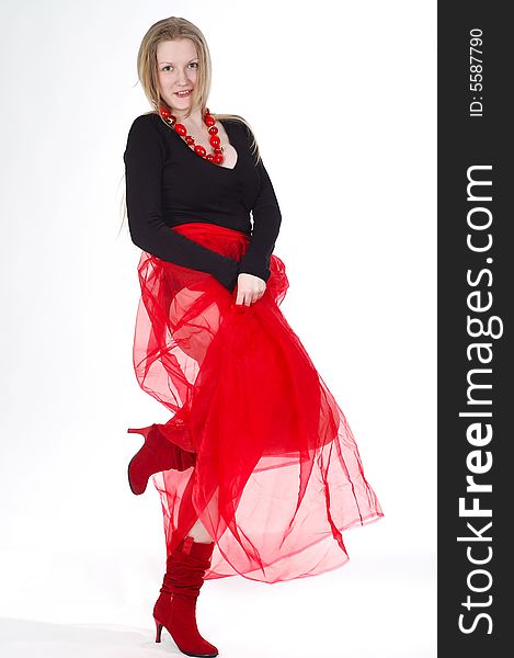 Young girl wearing red transparent skirt, high boots and beads