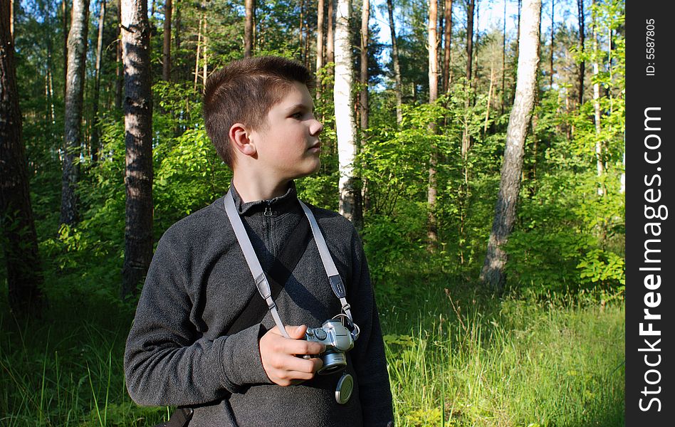 The young photo enthusiast in Lithuanian forest. The young photo enthusiast in Lithuanian forest.