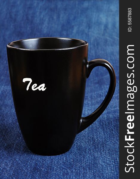 A tea mug isolated on blue.