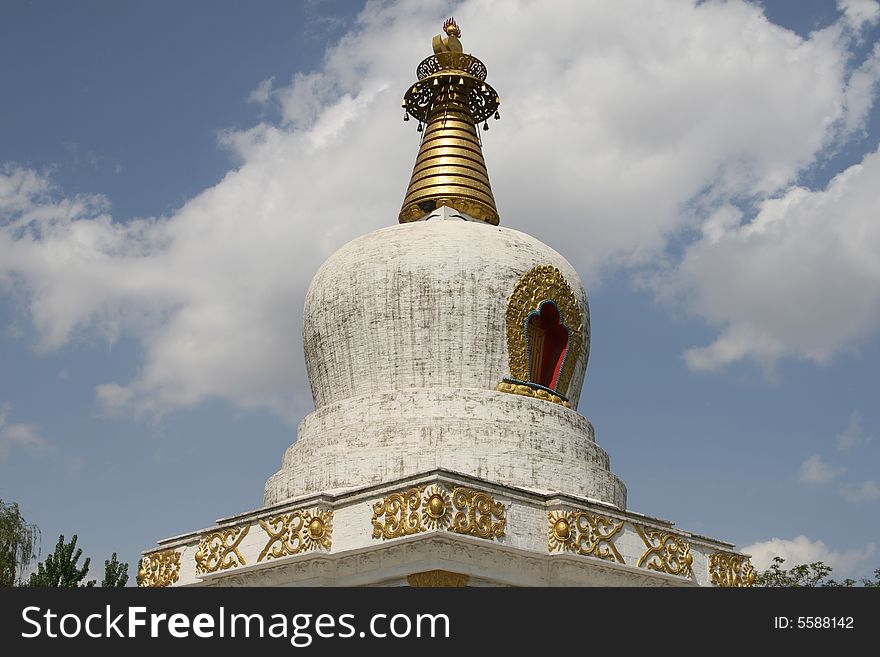 White pagoda in summer againt cloudy sky