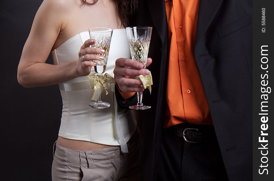 Man and woman hold in hands glasses with a champagne