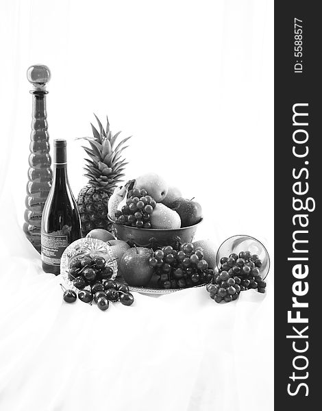 Black and white high key image of wine and fruit bowl. Black and white high key image of wine and fruit bowl.