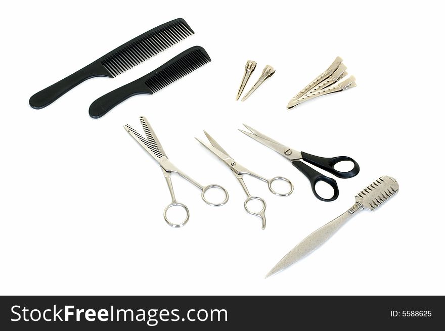 Set of pair of scissors and combs for hairdo on white background, studio shot. Set of pair of scissors and combs for hairdo on white background, studio shot