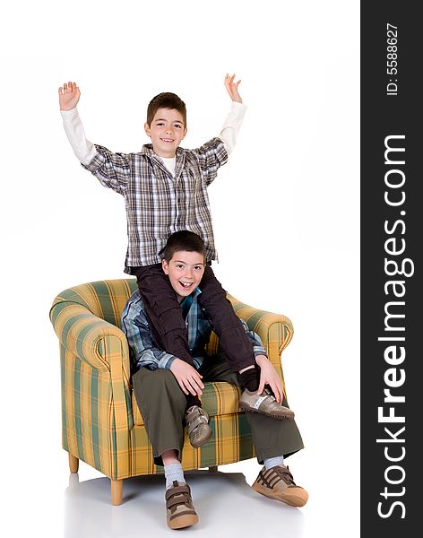 Two young happy smiling boys playing in the chair. Two young happy smiling boys playing in the chair