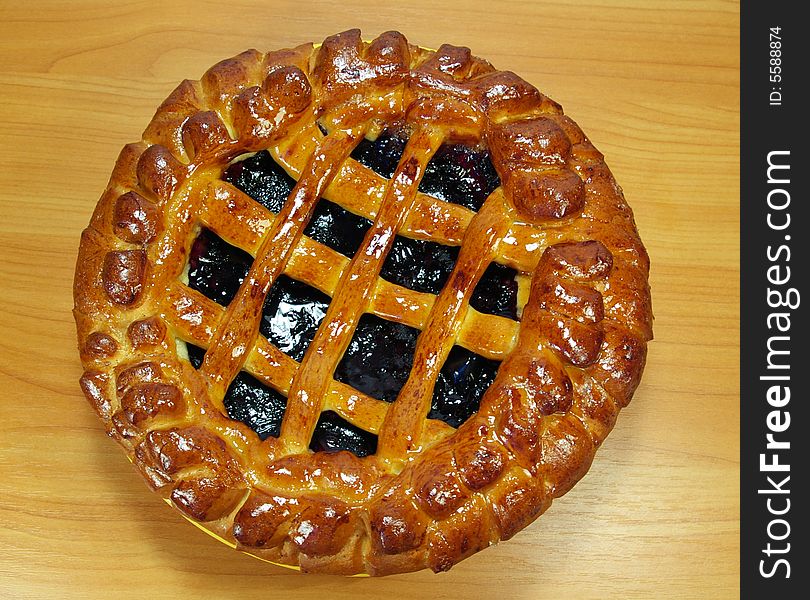 Fresh sweet pie with bilberry on a yellow plate. Fresh sweet pie with bilberry on a yellow plate