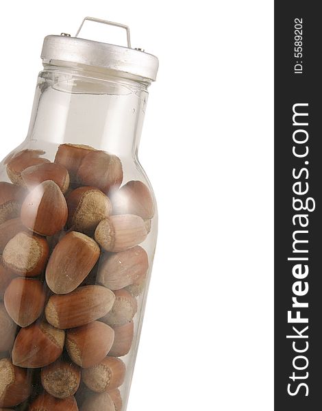 Whole hazelnuts in bootle. White background