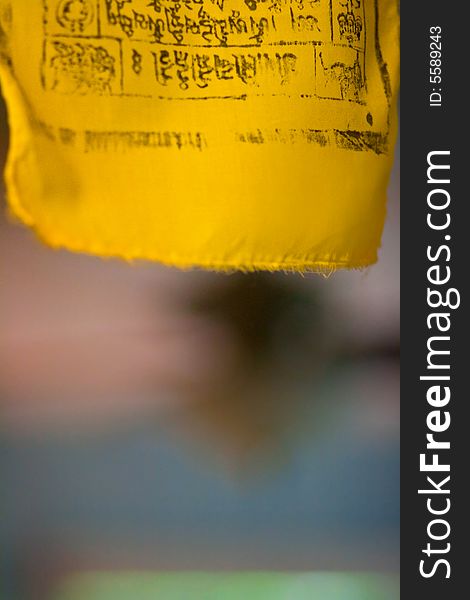 Tibetan Buddhist prayer flag blowing in the breeze. Abstract composition, good for a background. Short depth of field.