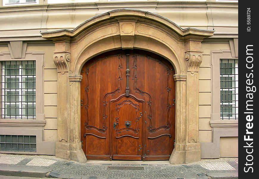 Old wooden portal of  in Prague with two pillars on a side