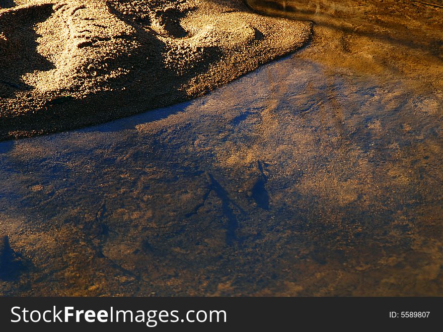 Still and transparent water of a brook with a beach. Still and transparent water of a brook with a beach