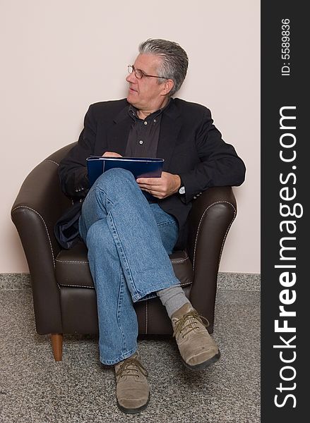 A business man writing a report in while in his study