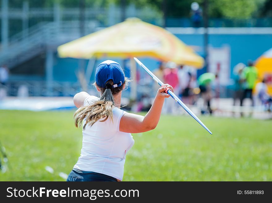Girl athlete throwing javelin