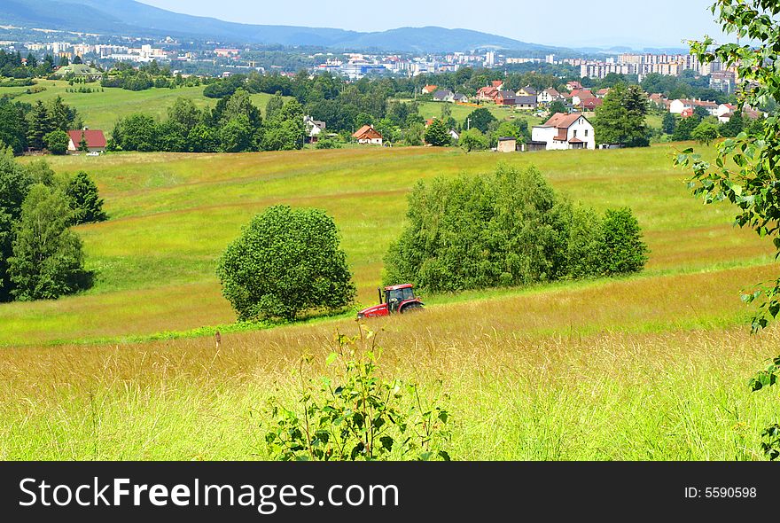 Privacy farmer mowing grass. The farm is located near the city. Privacy farmer mowing grass. The farm is located near the city.