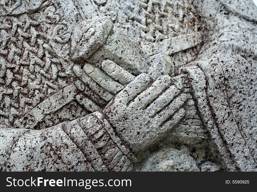 Hands of a stone statue.