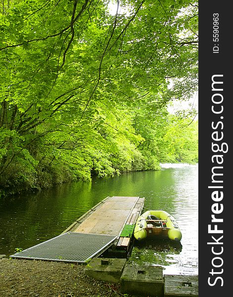 A green smal boat near pier. A green smal boat near pier