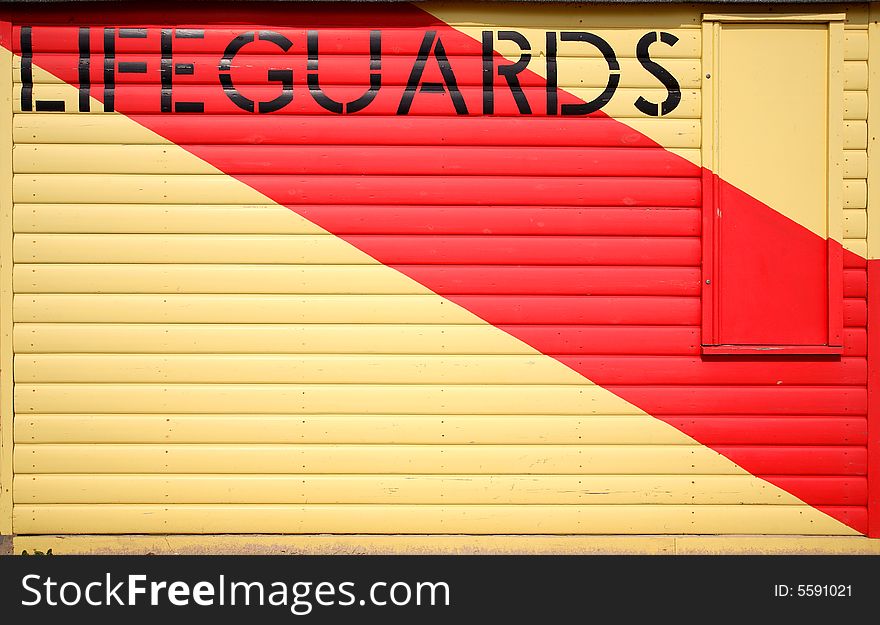 Wooden lifeguards hut with painted stripe
