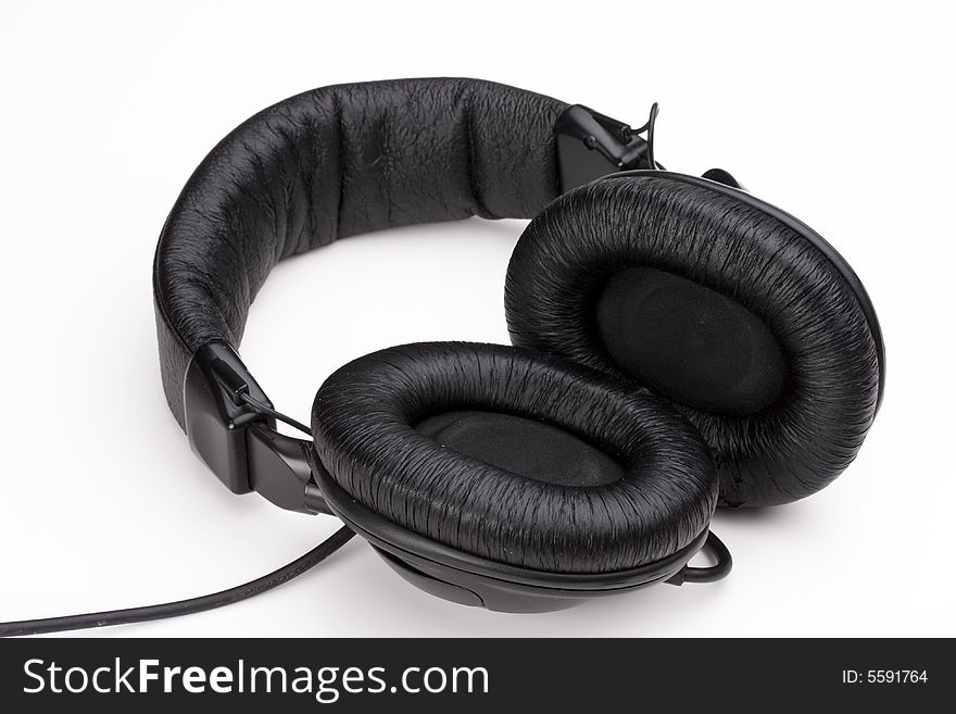 Professional used black audio headphones on white background