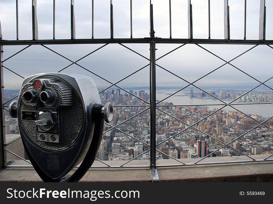 Binoculars on an observation deck looking over the city. Binoculars on an observation deck looking over the city