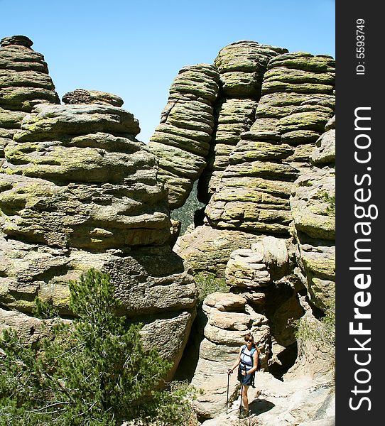 A Woman on a Hike Pauses Amongst the Weird Pinnacles Called 'Standing Up Rocks' Along the Echo Canyon Trail, Chiricahua National Monument, Arizona. A Woman on a Hike Pauses Amongst the Weird Pinnacles Called 'Standing Up Rocks' Along the Echo Canyon Trail, Chiricahua National Monument, Arizona