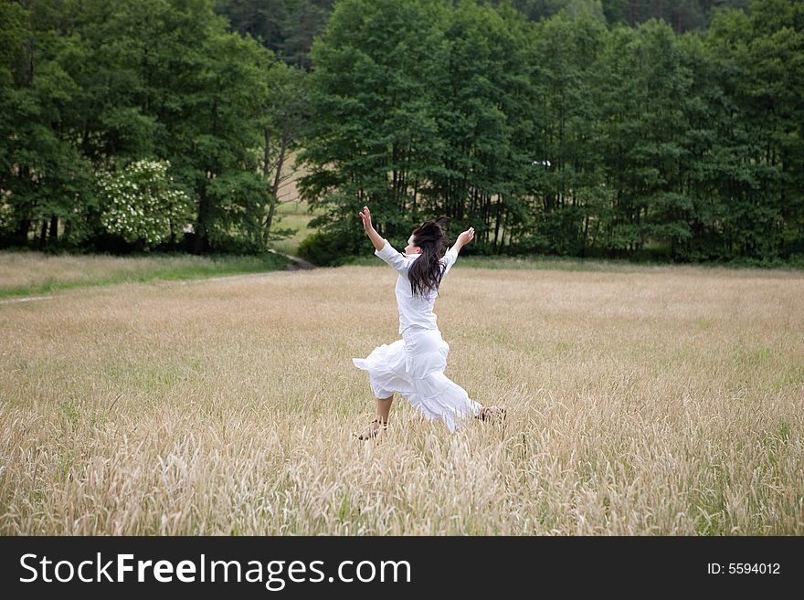 Happy woman jumping on green meadow. Happy woman jumping on green meadow