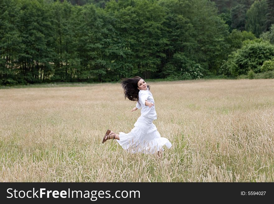 Happy woman jumping on green meadow. Happy woman jumping on green meadow