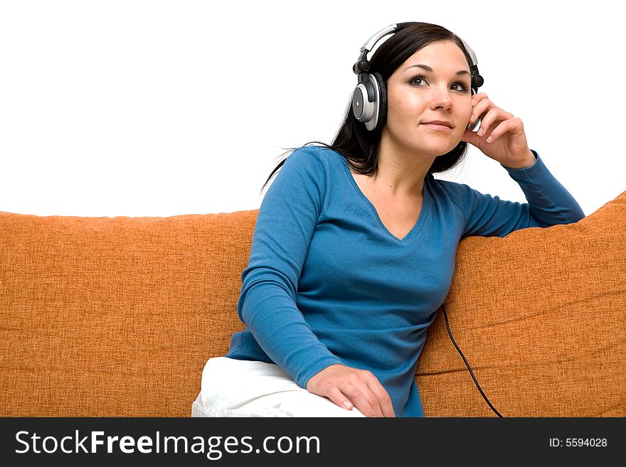 Attractive woman with headphones on sofa. Attractive woman with headphones on sofa