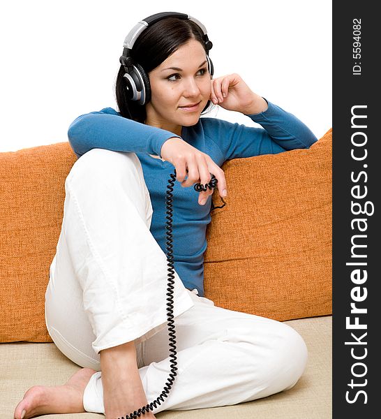 Attractive woman with headphones on sofa. Attractive woman with headphones on sofa